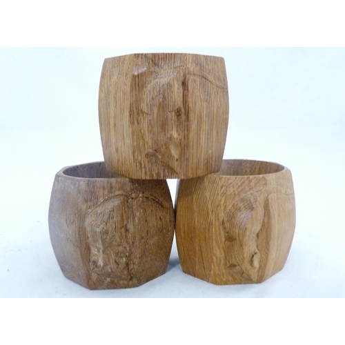 218 - Workshop of Robert 'Mouseman' Thompson of KilburnThree oak octagonal napkin rings, all bearing trade... 