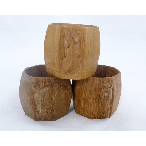 218 - Workshop of Robert 'Mouseman' Thompson of KilburnThree oak octagonal napkin rings, all bearing trade... 