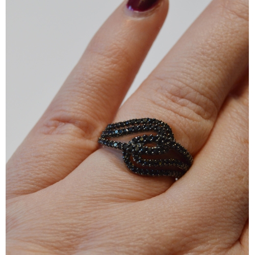 110 - Lady's dress ring with swirls of black diamonds, in 9ct gold, size N, 5g gross.