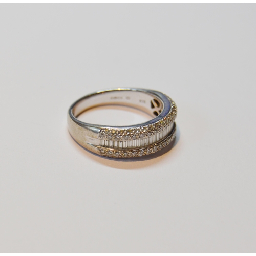 131 - Diamond half eternity ring with a band of baguettes flanked by bands of small brilliants, in 18ct wh... 