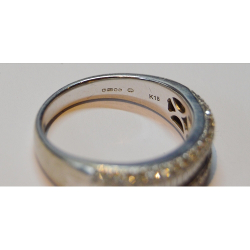 131 - Diamond half eternity ring with a band of baguettes flanked by bands of small brilliants, in 18ct wh... 