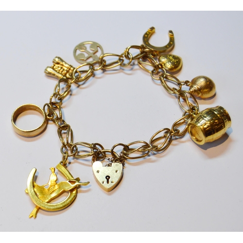 141 - 9ct gold padlock bracelet with dependant charms, marked '375' to most, 22g gross.