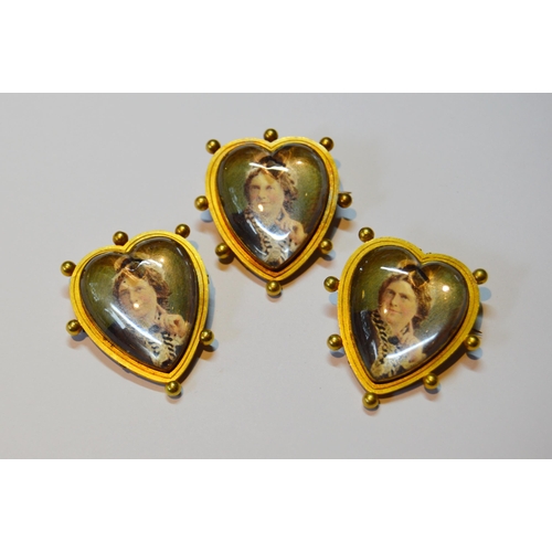 115 - Set of three Victorian gold mourning brooches of heart shape with tinted photographs under crystal, ... 