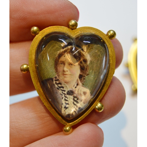 115 - Set of three Victorian gold mourning brooches of heart shape with tinted photographs under crystal, ... 