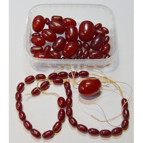 162 - Collection of Bakelite cherry amber beads, loose, probably from two strands, largest approximately 2... 