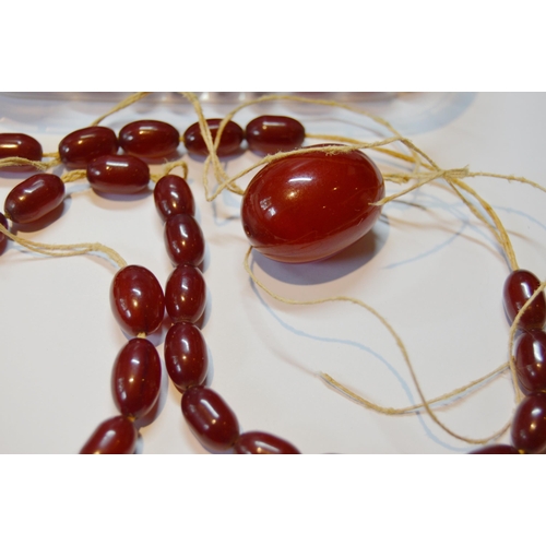 162 - Collection of Bakelite cherry amber beads, loose, probably from two strands, largest approximately 2... 