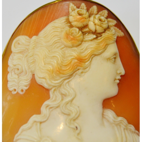 169 - Victorian shell cameo brooch depicting a woman, in slim gold mount.