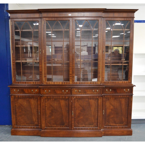 453 - Reproduction Georgian-style mahogany four-door breakfront library bookcase on cupboard base, with de... 