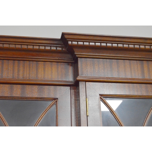 453 - Reproduction Georgian-style mahogany four-door breakfront library bookcase on cupboard base, with de... 