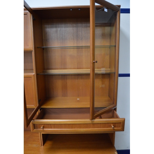 454 - McIntosh of KirkcaldyTeak display unit with two glazed doors enclosing glass shelves above a drawer ... 