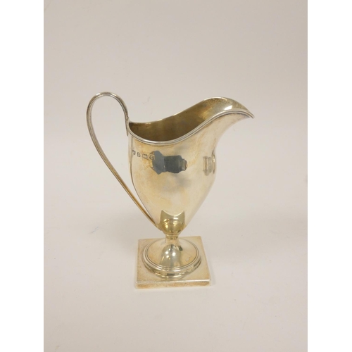 20 - Silver cream jug of helmet form, a cream boat, butter shell, and a glass preserve pot with silver li... 