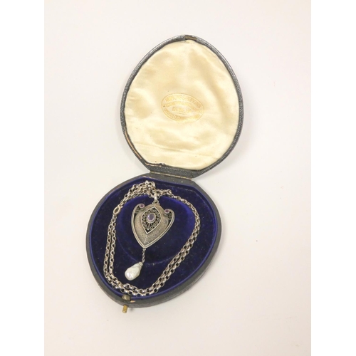 33 - Early 20th century continental silver pendant in the jugendstil style with central amethyst in filig... 