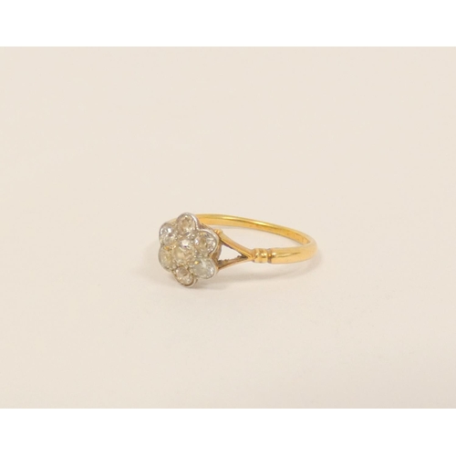 34 - Gold diamond seven stone cluster ring with millgrain set brilliants, 8.5mm across. Size N. 2g