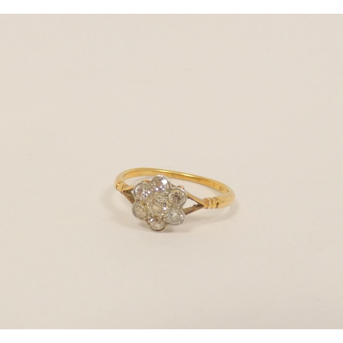 34 - Gold diamond seven stone cluster ring with millgrain set brilliants, 8.5mm across. Size N. 2g