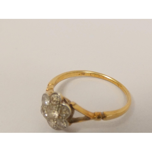 34 - Gold diamond seven stone cluster ring with millgrain set brilliants, 8.5mm across. Size N. 2g