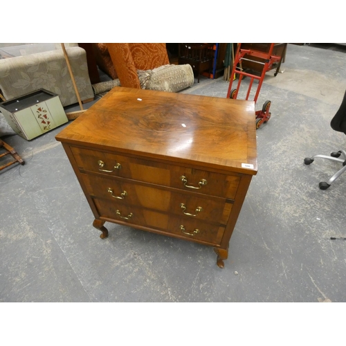 506 - Walnut style chest of three drawers on raised legs.