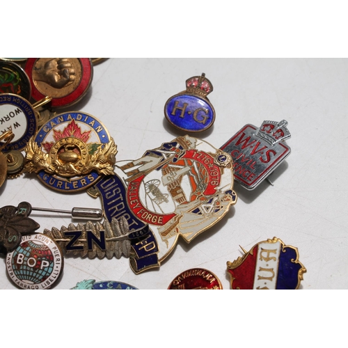 661 - Group of enamel and other badges and pins to include a silver ARP badge, British Red Cross, Canadian... 