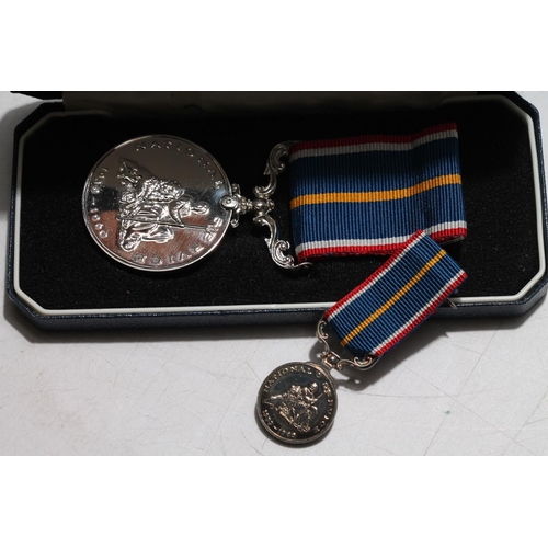 663 - National Service medal and matching miniature medal in Royal British Legion case.