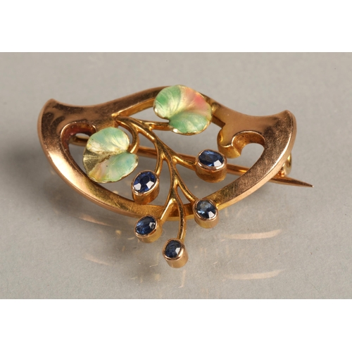 100 - 15K gold brooch set with sapphires and enamelled leaf detail, 3g