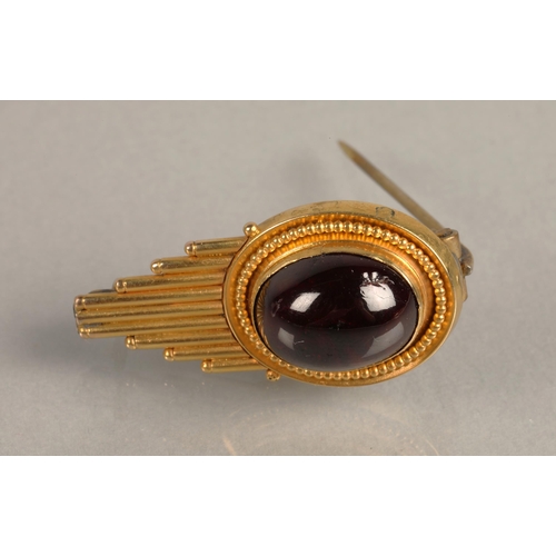 103 - Yellow metal brooch set with a ruby coloured cabochon gem, 4g