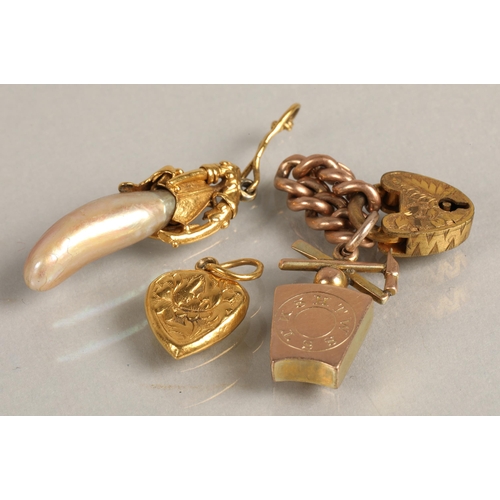 113 - Assorted yellow metal charms including pearl bean, heart padlock, 9ct gold masonic, and small amount... 