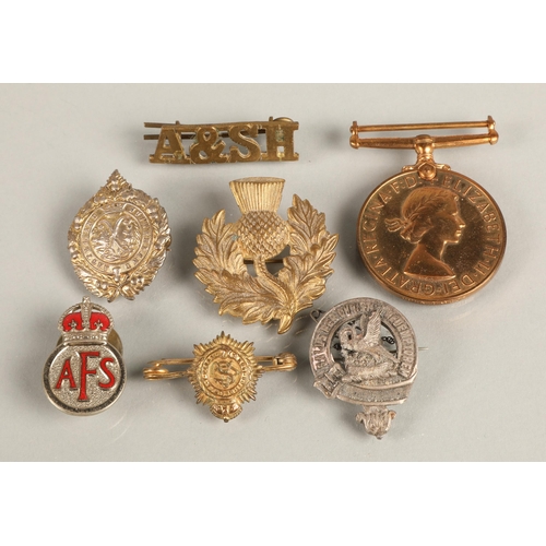 115 - Military badges and a medal 'For Faithful Service in the Special Constabulary' awarded to and engrav... 