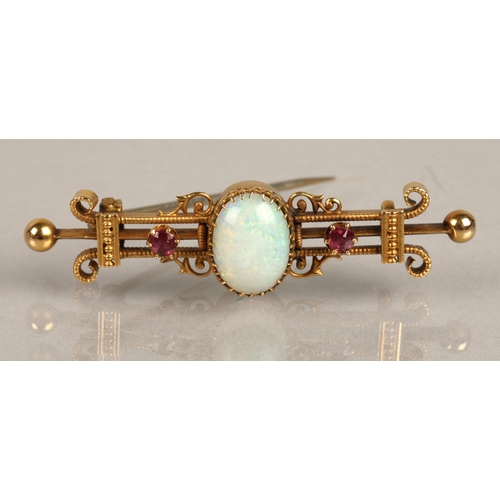 58 - 15K marked yellow metal bar brooch set with opal cabochon and two pink gems, gross weight 3.2g