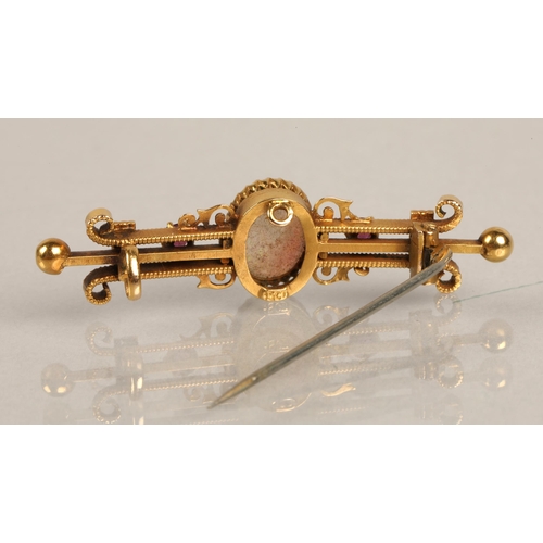 58 - 15K marked yellow metal bar brooch set with opal cabochon and two pink gems, gross weight 3.2g