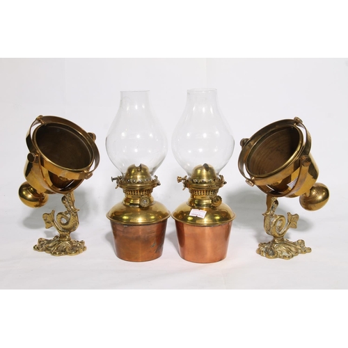 108 - Pair of brass gimbal mounted wall sconces with dolphin brackets holding Sherwood Ltd oil lamps.