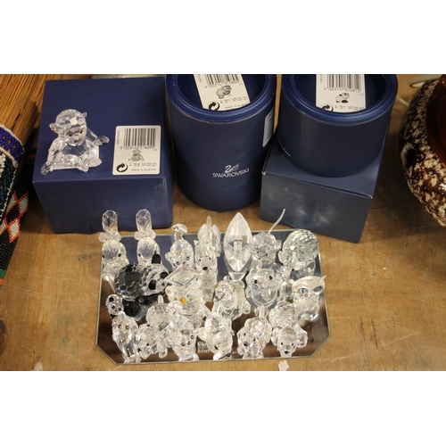 134 - Swarovski Crystal animal models to include a monkey and a panda, both boxed, elephants, ducks, dogs,... 