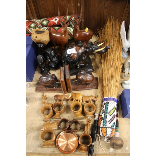 137 - African wood carvings to include animal napkin rings, elephant bookends, antelope, etc., also a bead... 