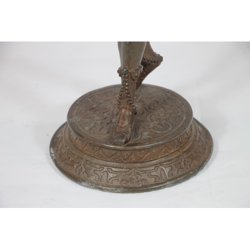 14 - Cast spelter bronzed candle stand with Blackamoor figural support, 43cm high.