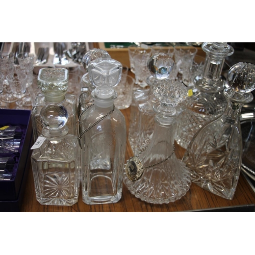 163 - Pair of Edinburgh Crystal whisky tumblers, boxed, and eight cut-glass decanters, some with labels.