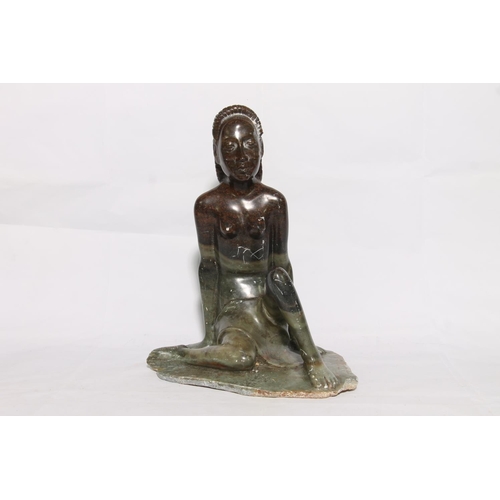 175 - Carved soapstone figure of a seated lady, 40cm high.