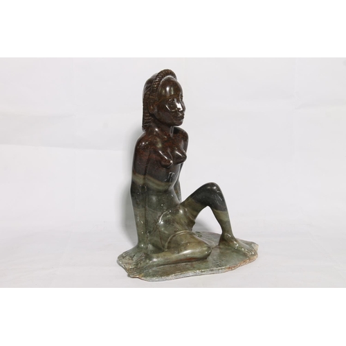 175 - Carved soapstone figure of a seated lady, 40cm high.