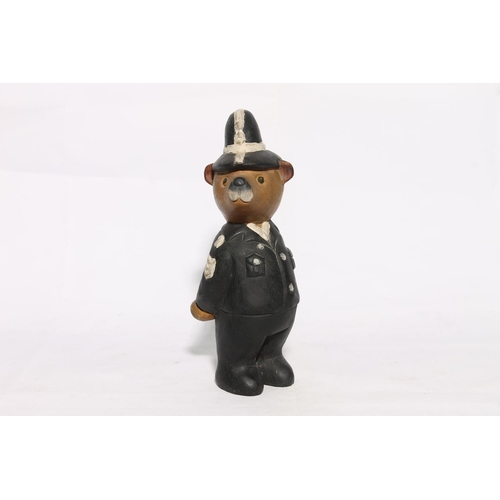 177 - Carved and painted model of a teddy in police officer uniform, 28cm high.