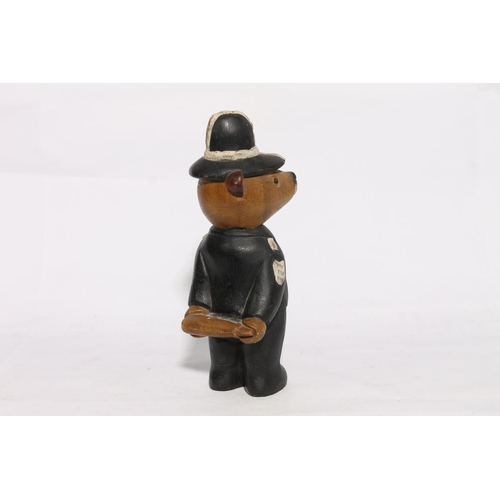 177 - Carved and painted model of a teddy in police officer uniform, 28cm high.