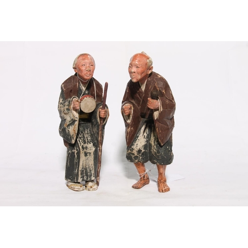 180 - Pair of oriental chip carved painted wooden figures, 25cm.