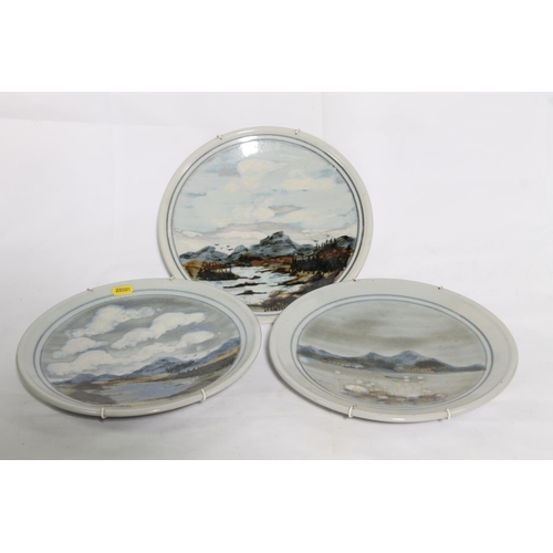 201 - Three Highland Stoneware dishes with hand-painted landscape scenes, 26cm diameter.