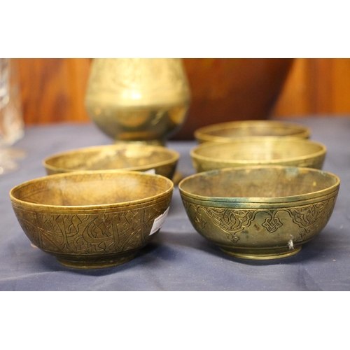 23 - Indian brass baluster vase with trumpet rim and five Arabic brass bowls.