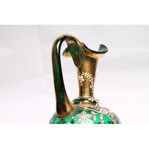 233 - Bohemian green glass ewer in the manner of Moser with hand-painted enamel flower decoration, 20cm hi... 