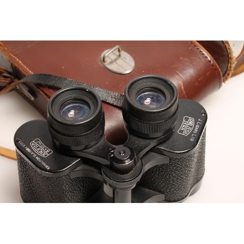 243 - Pair of Carl Zeiss Jenoptem 8x30 binoculars, in brown leather case.