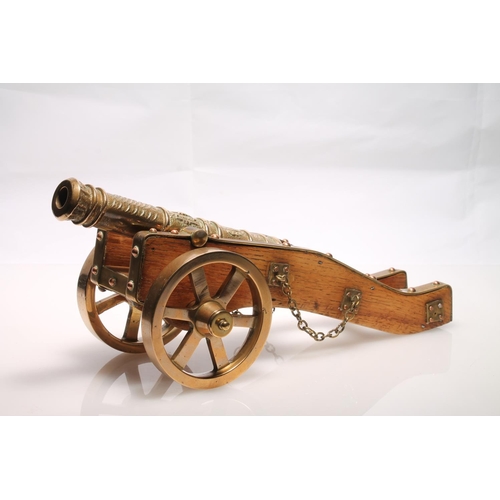 248 - Brass bound model of a firing canon, 33cm long.