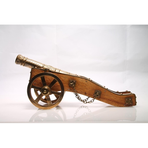 248 - Brass bound model of a firing canon, 33cm long.