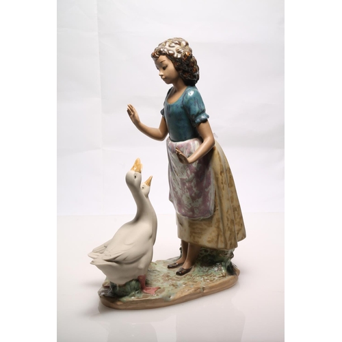 252 - Nao by Lladro gres figurine of a girl with geese, 30cm high.