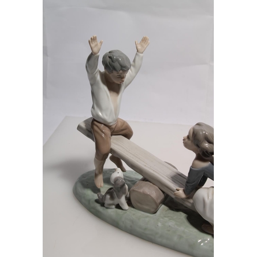 253 - Two Lladro figurines to include a girl and boy on see-saw and girl and boy with sailing boat.  ... 