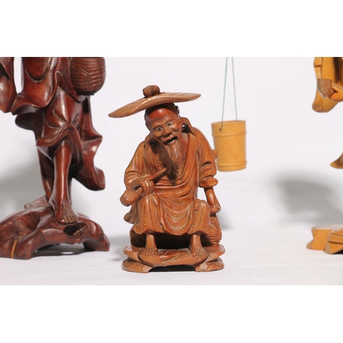 37 - Three Chinese carved wooden figures, largest 26cm high.