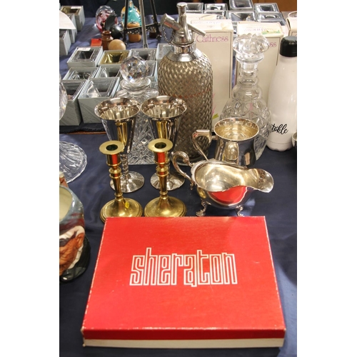 56 - Vintage soda syphon, two glass decanters, a pair of brass candlesticks, boxed placemats and silver-p... 