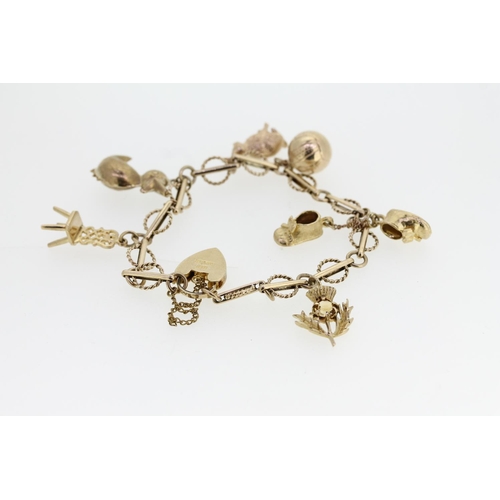 464 - 9ct gold charm bracelet with heart shaped clasp and holding six individually hallmarked 9ct gold cha... 