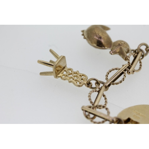 464 - 9ct gold charm bracelet with heart shaped clasp and holding six individually hallmarked 9ct gold cha... 